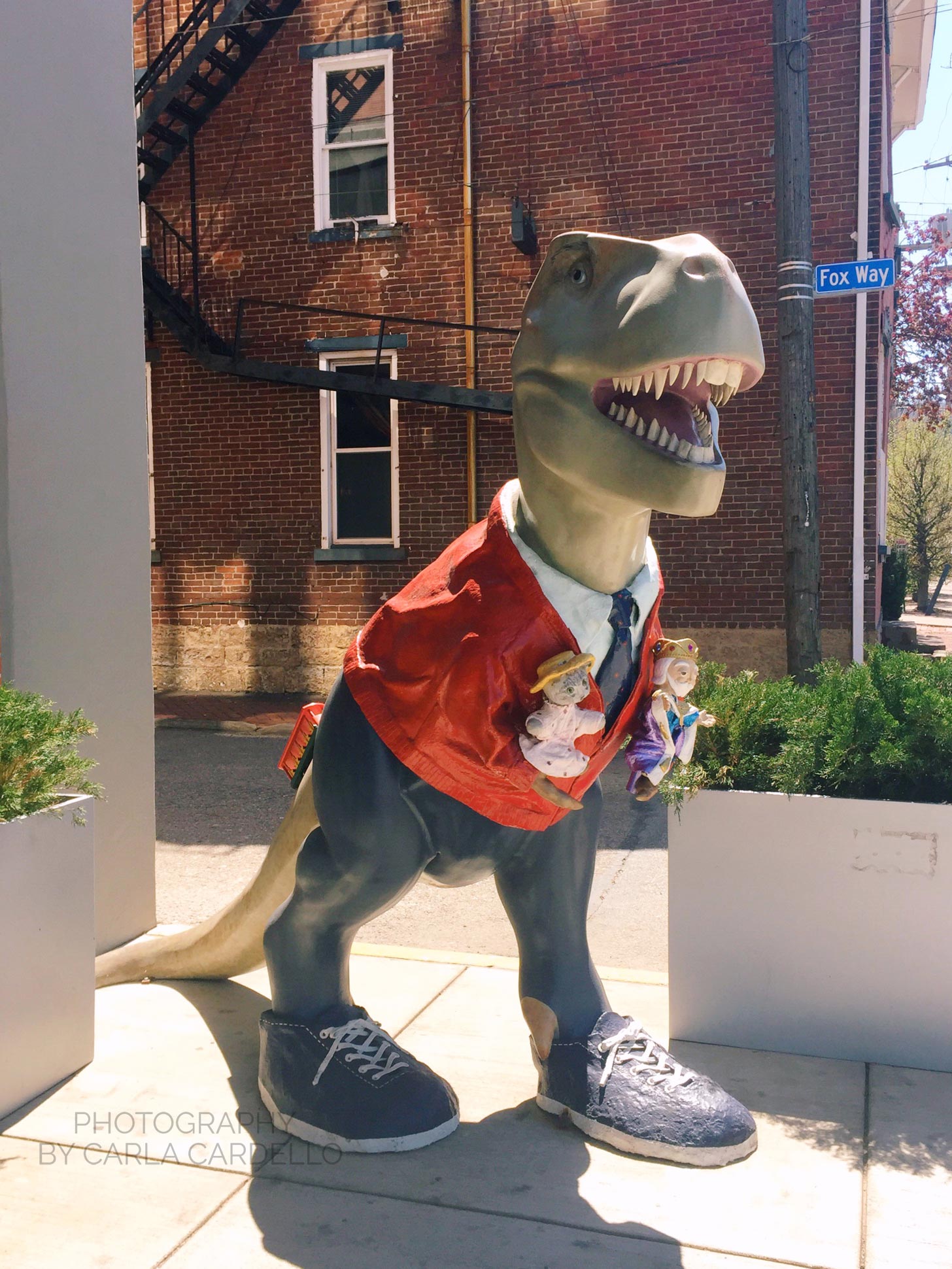 Fredosaurus Rex Pittsburgh Dinosaur Statue with red trolley on tail